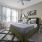 Large well lit bedroom with two large windows. 